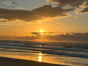 Wave rolling into ocean at Tallow Beach, symbolizing oneness with God