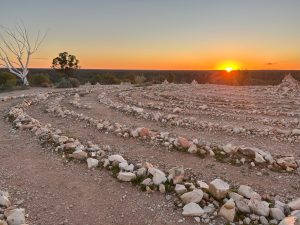 A glowing stone labyrinth at sunset - Spiritual awakening.