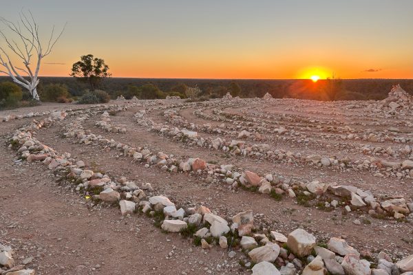 A glowing stone labyrinth at sunset - Spiritual awakening.