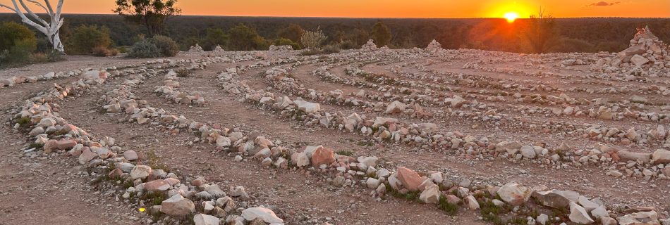 A glowing stone labyrinth at sunset - Spiritual awakening.