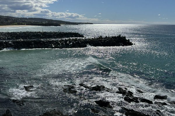 Ocean waves flowing gently through a narrow rock channel at high tide, symbolising the quiet opening that leads to spiritual harmony and inner peace.