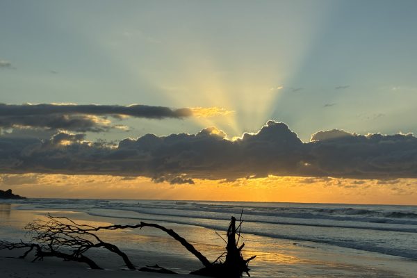 Soft light breaking through clouds over the ocean, symbolising spiritual truth emerging from moments of perceived failure.