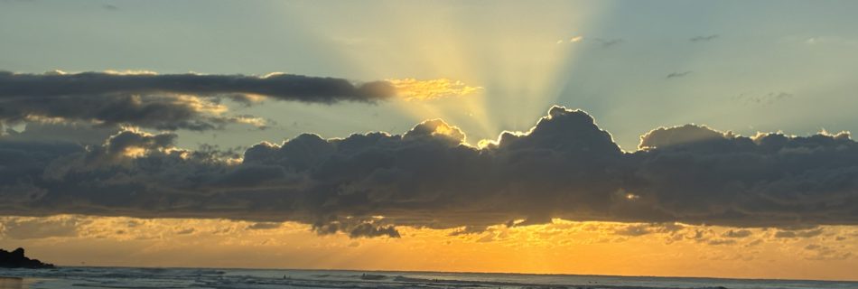 Soft light breaking through clouds over the ocean, symbolising spiritual truth emerging from moments of perceived failure.